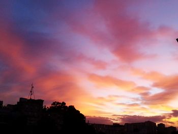 Low angle view of buildings against sky at sunset