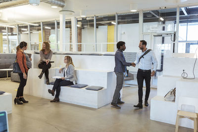 Business colleagues talking with each other in modern office