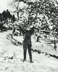 Woman standing on tree trunk