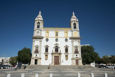 Low angle view of igreja do carmo at faro against clear blue sky