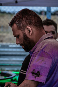 Portrait of young man using mobile phone outdoors