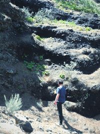 Rear view of man walking in water