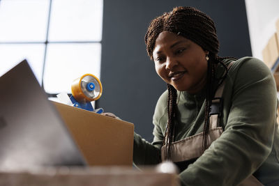 Portrait of young woman using laptop