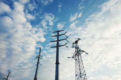 Low angle view of electricity pylon against sky