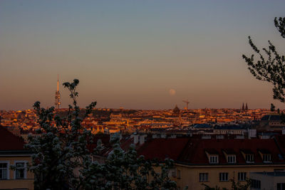 Buildings in city at sunset