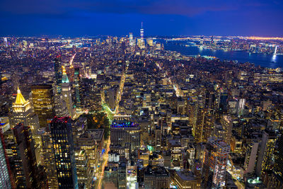 High angle view of illuminated city buildings at night