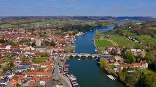 Aerial view of river amidst buildings in town