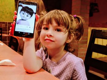 Close-up portrait of girl photographing