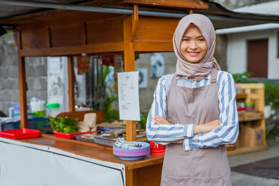 Portrait of young woman standing in store