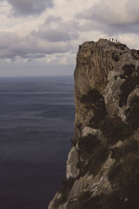 Rock formations by sea against sky