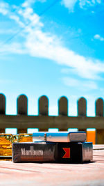 Close-up of row on table against blue sky