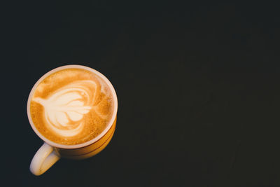 Close-up of coffee cup against black background