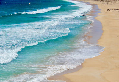 High angle view of waves rushing towards shore