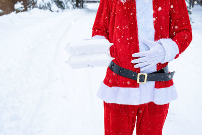 Midsection of woman standing on snow