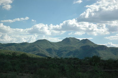 Scenic view of mountains against cloudy sky