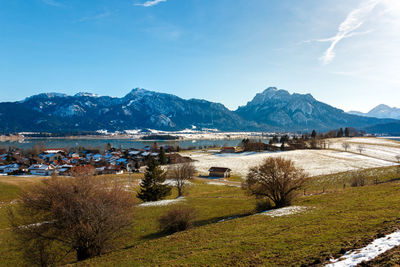 Scenic view of building and mountains against sky