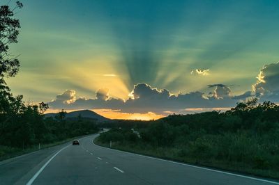 Road amidst landscape against sky during sunset