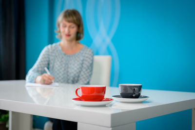 Close-up of woman sitting on table