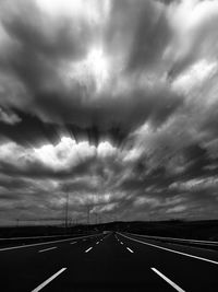 View of highway against cloudy sky