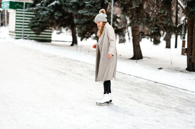 Full length of woman standing on snow