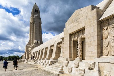 Low angle view of old building against cloudy sky