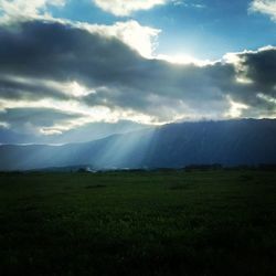 Scenic view of mountains against cloudy sky