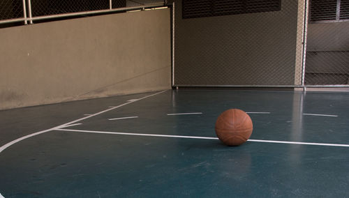 Close-up of ball on floor at court