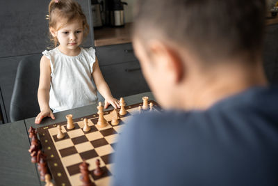 Side view of boy playing chess