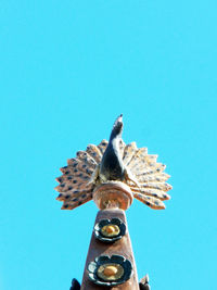 Low angle view of a statue against blue sky