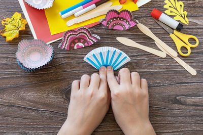 High angle view of human hand on table