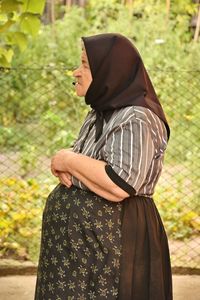 Rear view of woman standing outdoors