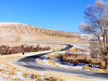 Narrow road along countryside landscape