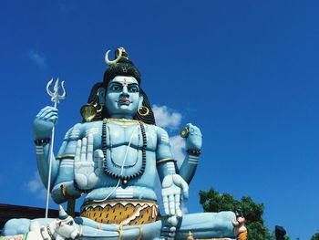 Statue of shiva at koneswaram temple against sky