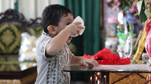 Side view of boy looking at table