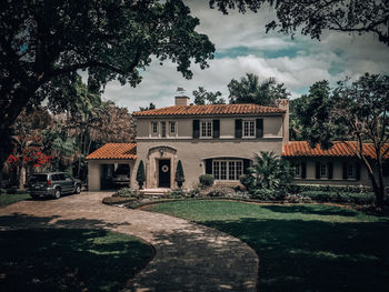 Footpath by buildings against sky
