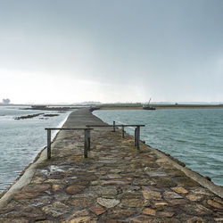 Pier over sea against sky