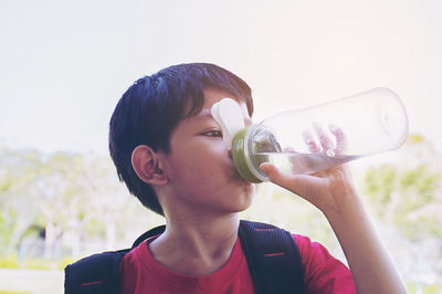 Boy drinking water from bottle