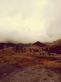 Scenic view of mountains against cloudy sky