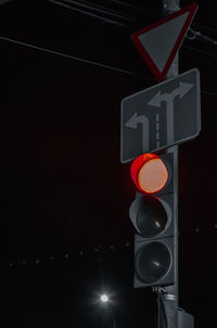 Low angle view of illuminated street light at night