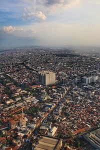 High angle view of modern buildings in city against sky