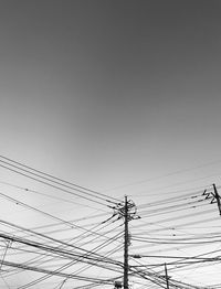 Low angle view of electricity pylon against sky