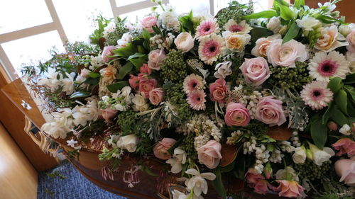 Closeup shot of a funeral casket or coffin in a hearse or chapel or burial at cemetery
