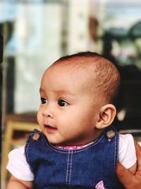 Close-up of cute baby girl at home