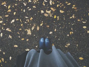 Low section of person standing on tiled floor