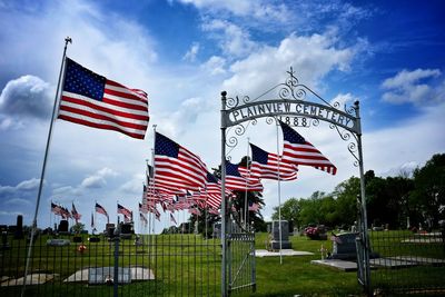 Low angle view of american flag against cloudy sky