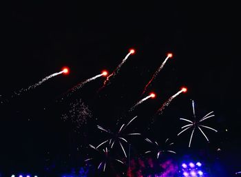 Low angle view of firework display at night