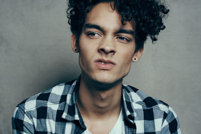 Portrait of young man against wall