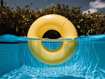 Low angle view of inflatable ring in swimming pool