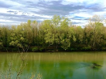 Scenic view of lake against cloudy sky