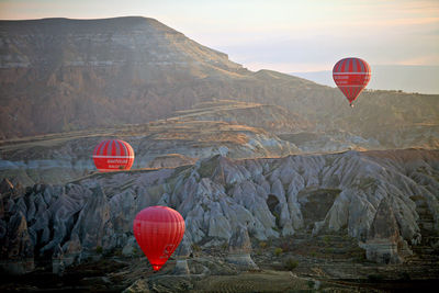 Hot air balloon flying over mountain